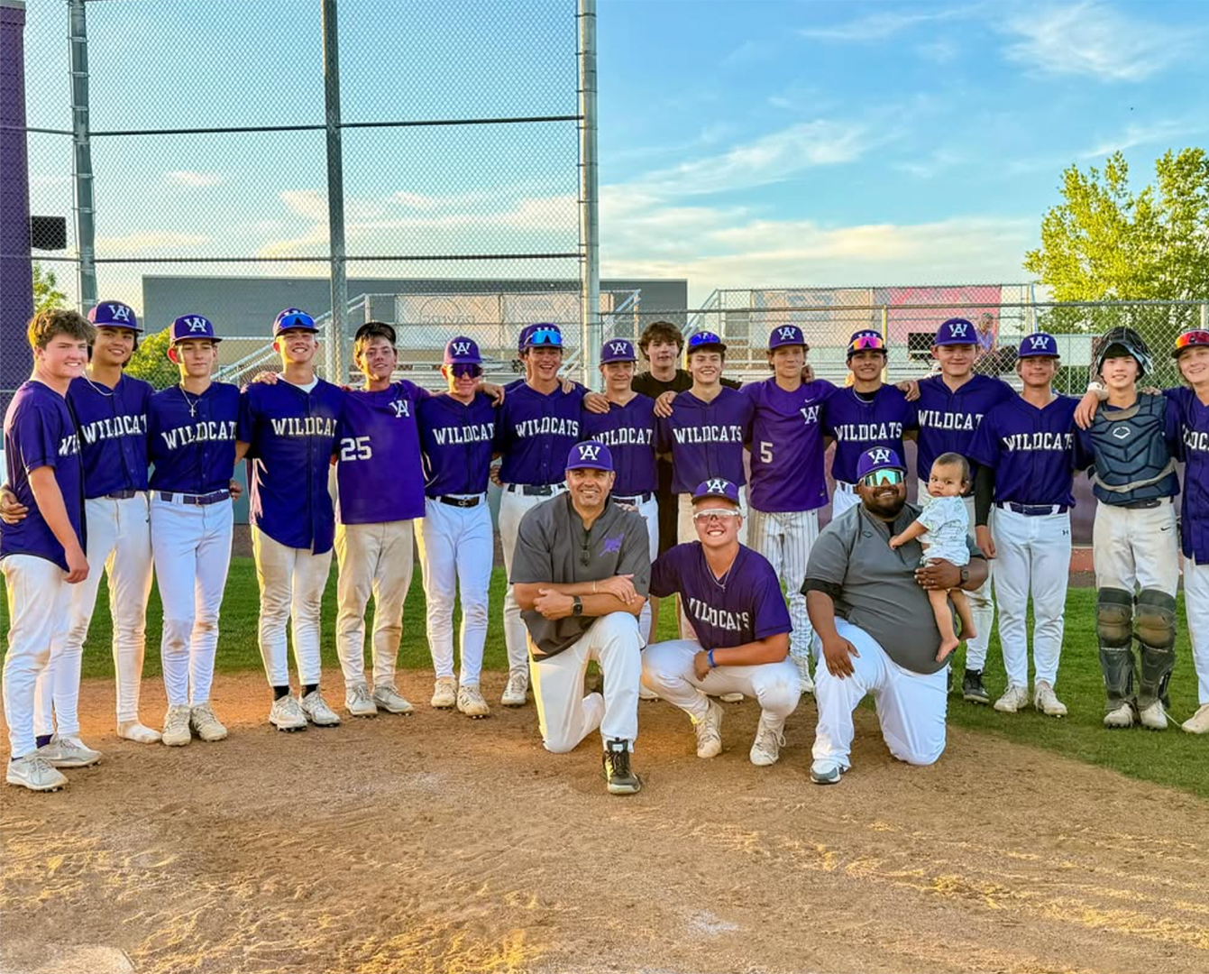 Group Loan Officer Dennis Marshall (front row, far left) posing with the Arvada West JV baseball team after claiming the League title and capping a 16-2 season.